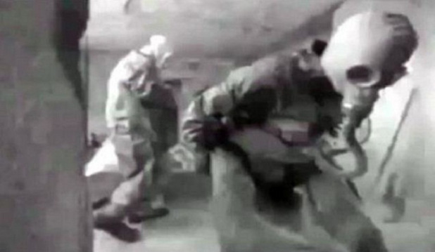 Russian military personnel with protective gear entering the tomb